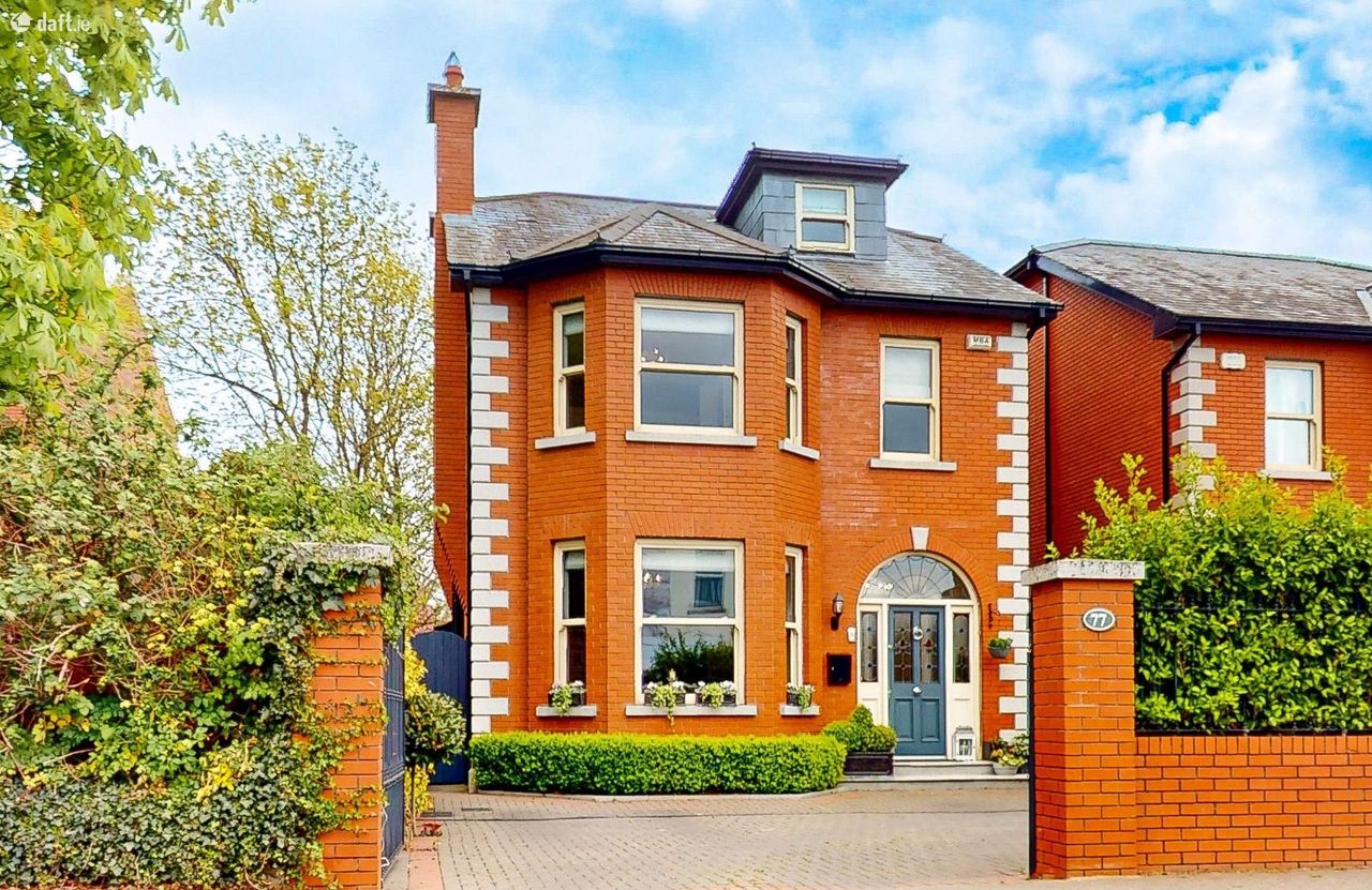 Detached red-brick period house with bay windows and a paved driveway